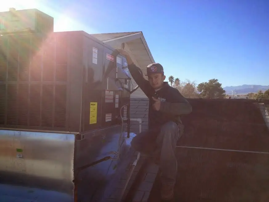 HVAC technician performing AC Tune-Up on a rooftop unit in South Pasadena